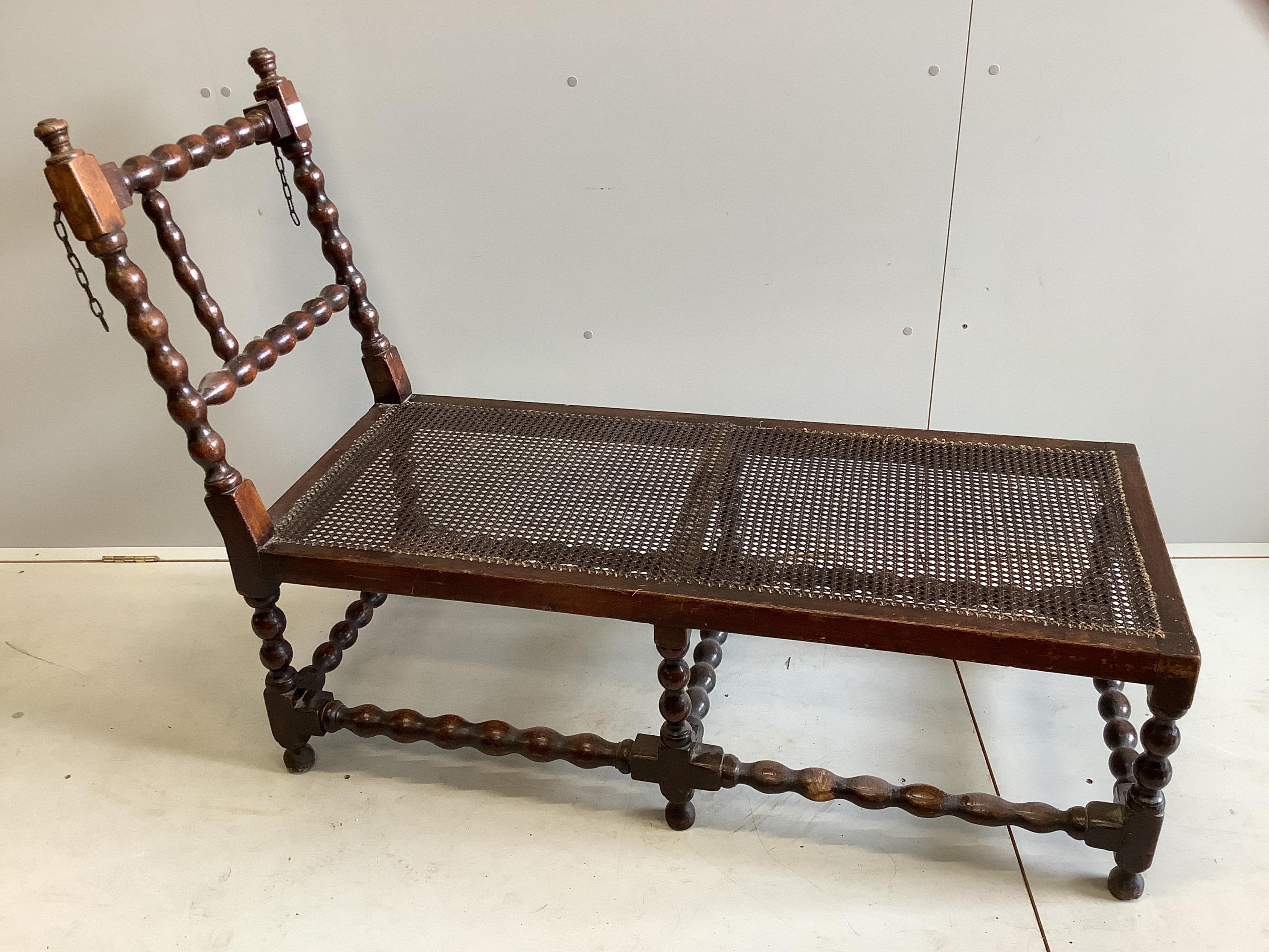 An early 20th century oak frame daybed, width 131cm, depth 53cm, height 97cm. Condition - poor